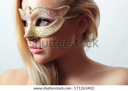Beautiful Blond Woman in Carnival Mask.Masquerade. Sexy Girl. Beauty & Fashion