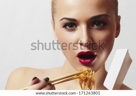 Beautiful Woman with Chinese Noodles.Red Lips.Sticks. Fast Food Delivery. Enjoy meal
