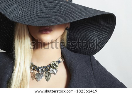 Beautiful Blond Woman in Black Hat. Close-up. Elegance Beauty Girl.Spring Shopping. Accessories. Lady in Jewelry
