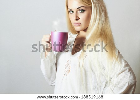 Beautiful blond woman drinking Coffee. Cup of tea. Hot drink. Sweet girl in the Morning
