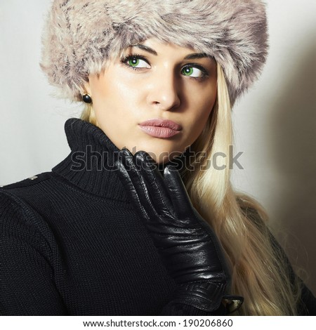Young Woman in Fur Hat. Beautiful Blond Girl in Black Leather Gloves. Winter Fashion Beauty