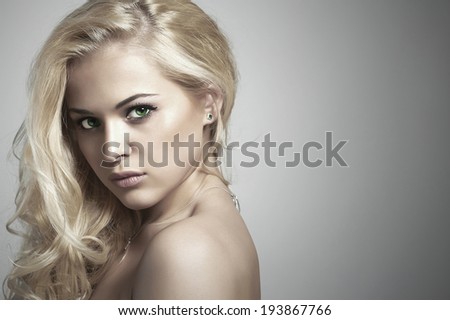 Fashion portrait of young beautiful woman.Sexy Blond girl. Gray Background.Your text here