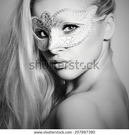 Beautiful Blond Woman in a Carnival Mask.Masquerade. Monochrome girl
