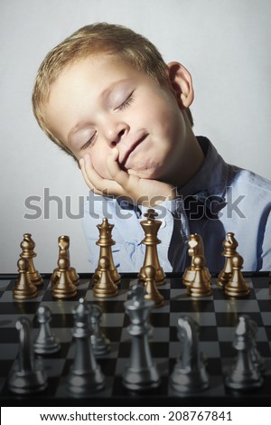 Fashionable Little boy playing chess.Funny kid.fashion children.5 Years Old Child. Chess board.grandmaster