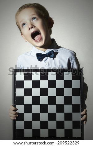Little boy with chessboard.Chess.Emotion.Scream child