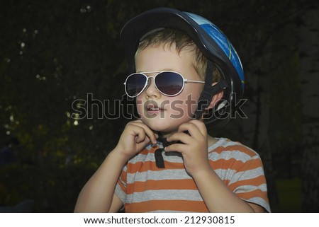 little boy in bicycle helmet.funny child in sunglasses.active life.outdoor