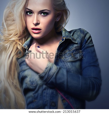 art fashion portrait of beautiful blond woman in jeans. denim blue jeans wear.Beauty Girl with Curly hair.Sexy woman.Long hair