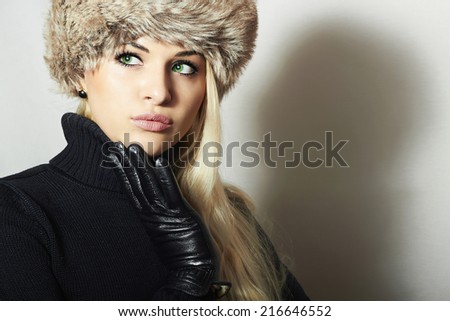 Beautiful Young Woman in Fur Hat. Pretty Blond Girl. Winter Fashion Beauty.Beautiful Blond Girl in Black Leather Gloves