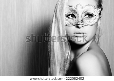 Beautiful Blond Woman in a Carnival Mask.Masquerade. Sexy Girl. art monochrome portrait.texture background