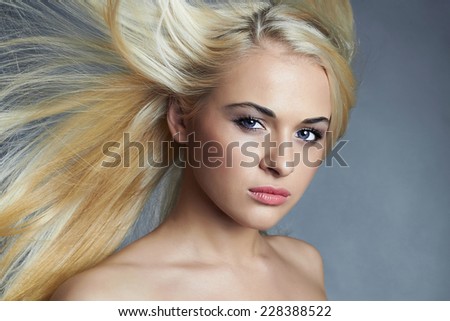 beautiful woman with blue eyes. Sexy blond girl. Beautiful healthy hair.Beauty salon.flying hair