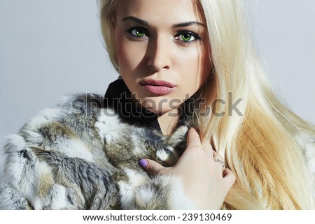 Beautiful blond woman in fur.winter fashion.Beauty Model Girl in Natural Fur Coat. Woman in Luxury Fur Jacket