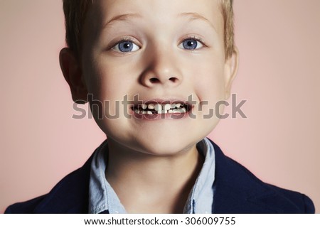 little boy showing that he lost first milk tooth.child with missing front tooth
