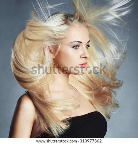 Fashion portrait of young beautiful woman. Flying hair Blond girl