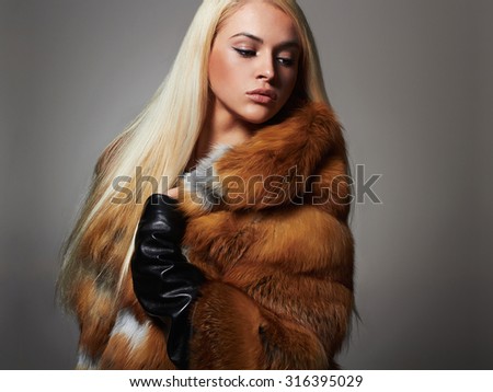 Winter Woman in Luxury Fur Coat. Beauty Fashion Model Girl. beautiful stylish blond girl Healthy hair