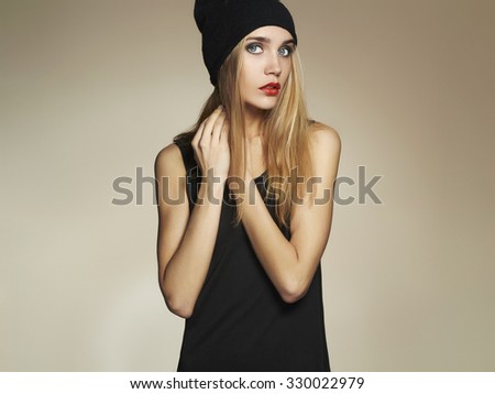 fashionable beautiful young woman in hat. beauty blond girl in cap. casual wear.winter fashion collection