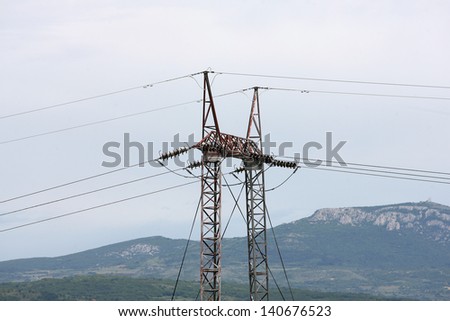 High-voltage power transmission tower the poles of a power line against a blue sky. high voltage power line