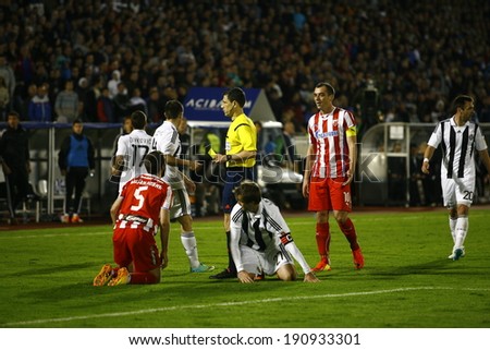 SERBIA, BELGRADE - APRIL 27, 2014: The referee preparing yellow card. Eternal rivals have met 146th times in the Eternal soccer derby, FC Partizan and Red Star from Belgrade, was played on 27 April.