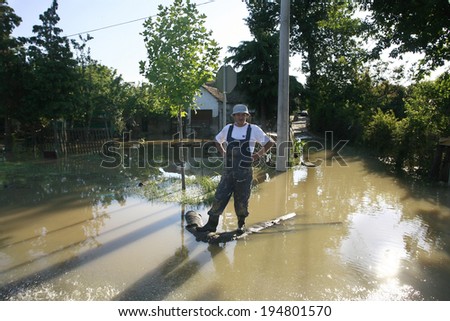 SERBIA, OBRENOVAC - MAY 21: A man standing in water in Obrenovac under water. The water level of Sava River remains high in worst flooding on record across the Balkans on may 21, 2014