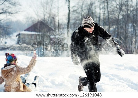 Young couple playing with snow