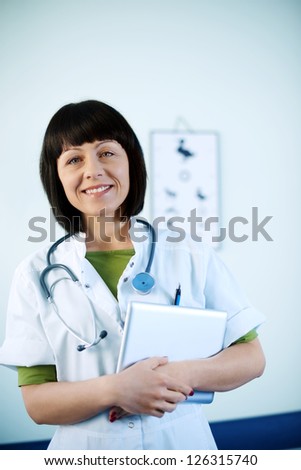 Smiling doctor holding tablet