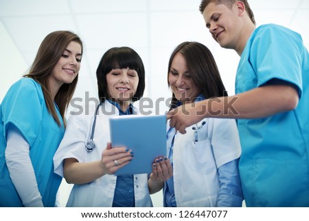 Medical team checking results on digital tablet