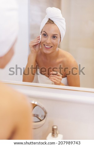 Woman removing makeup from her face