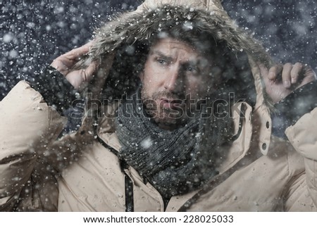 Handsome man in snow storm