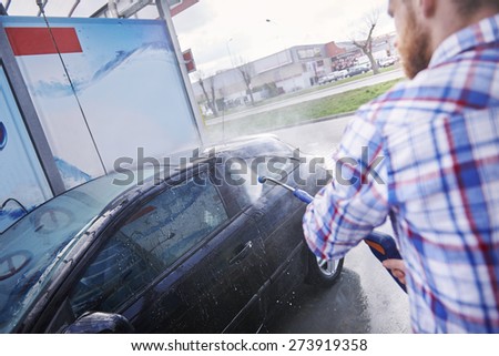 Cleaning the car with a pressure washer