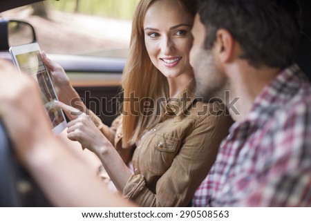Couple using a Touch Pad in the car