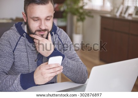 Young man browsing contacts in his telephone