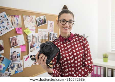 Professional photographer posing with her camera. Notice: we have proper MRs for images on the background