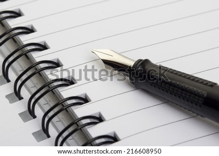 open notebook with stylish pen isolated on white