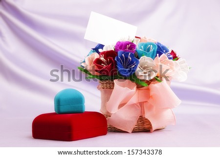 Basket with paper flowers, velvet boxes and blank card