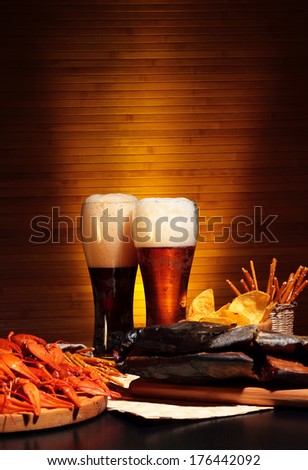 Glasses of dark and light beer with crawfish
