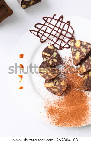 chocolate sausage on white plate with decorations