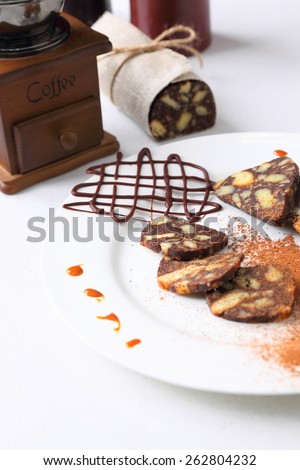 chocolate sausage on white plate with decorations
