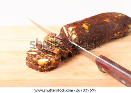 chocolate sausage on white dish with decorations
