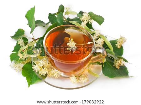 Linden tea in a transparent cup and linden blossoms isolated on white background