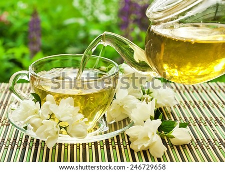 Jasmine tea pouring in a glass cup