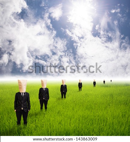 Business People businessman put  paper bag on head stand per row on grass field