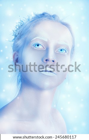 White woman with transparent eyes and white makeup under the snow