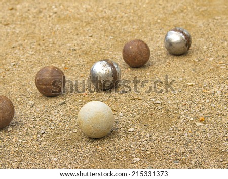 Petanque balls different on the ground.