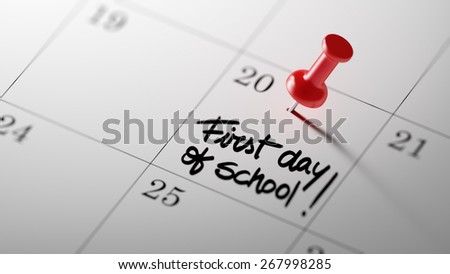 Concept image of a Calendar with a shiny red push pin. Closeup shot of a thumbtack attached. First day of school text note reminder concept. Words First day of school written in Black Marker.