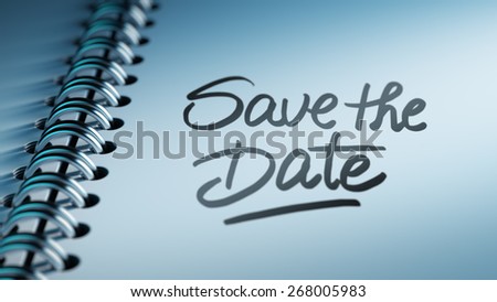 Closeup of a personal agenda marking a day of the month representing a organizing time and schedule. Save the date text note reminder concept. Words Save the date written in Black Marker.