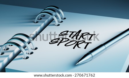 Closeup of a personal agenda setting an important date writing with pen. The words Start Sport written on a white notebook to remind you an important appointment.