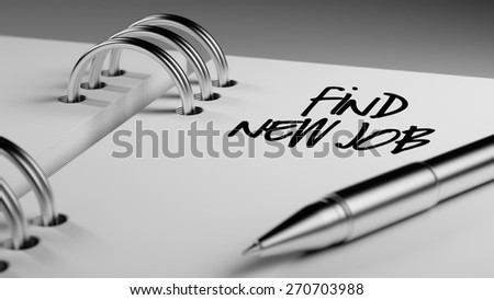 Closeup of a personal agenda setting an important date writing with pen. The words Find New Job written on a white notebook to remind you an important appointment.