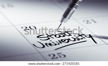 Concept image of a Calendar with a golden dart stick. The words Start University written on a white notebook to remind you an important appointment.
