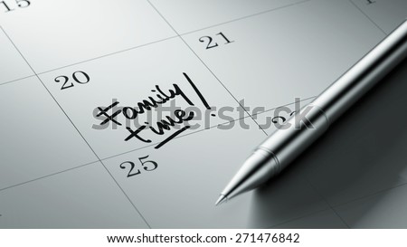 Closeup of a personal agenda setting an important date written with pen. The words Family Time written on a white notebook to remind you an important appointment.