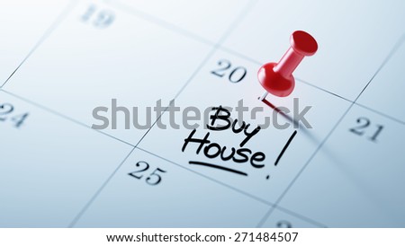 Concept image of a Calendar with a red push pin. Closeup shot of a thumbtack attached. The words Buy House written on a white notebook to remind you an important appointment.