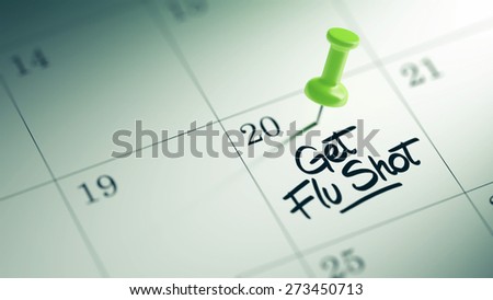 Concept image of a Calendar with a green push pin. Closeup shot of a thumbtack attached. The words Get Flu Shot written on a white notebook to remind you an important appointment.